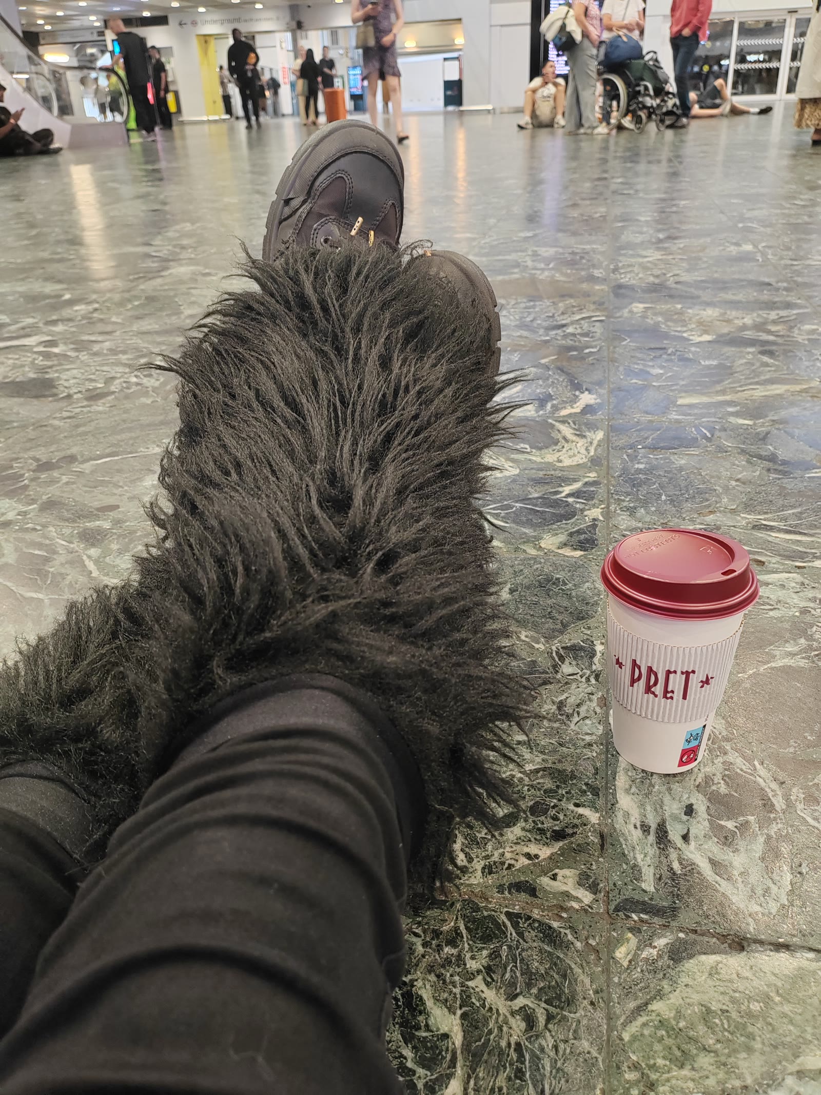 The full Euston floor vigil: legwarmers, coffee and absolutely no shame.
